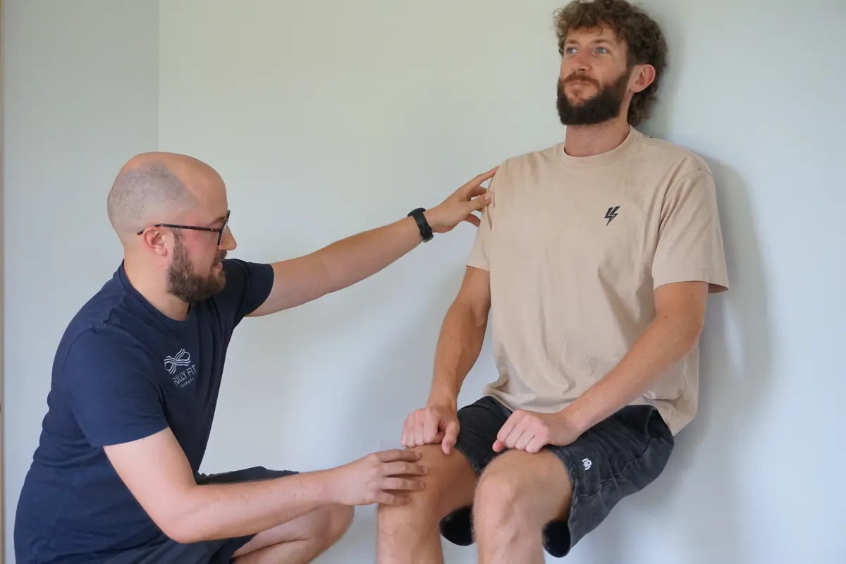 Rob assessing a seated client's knee movement