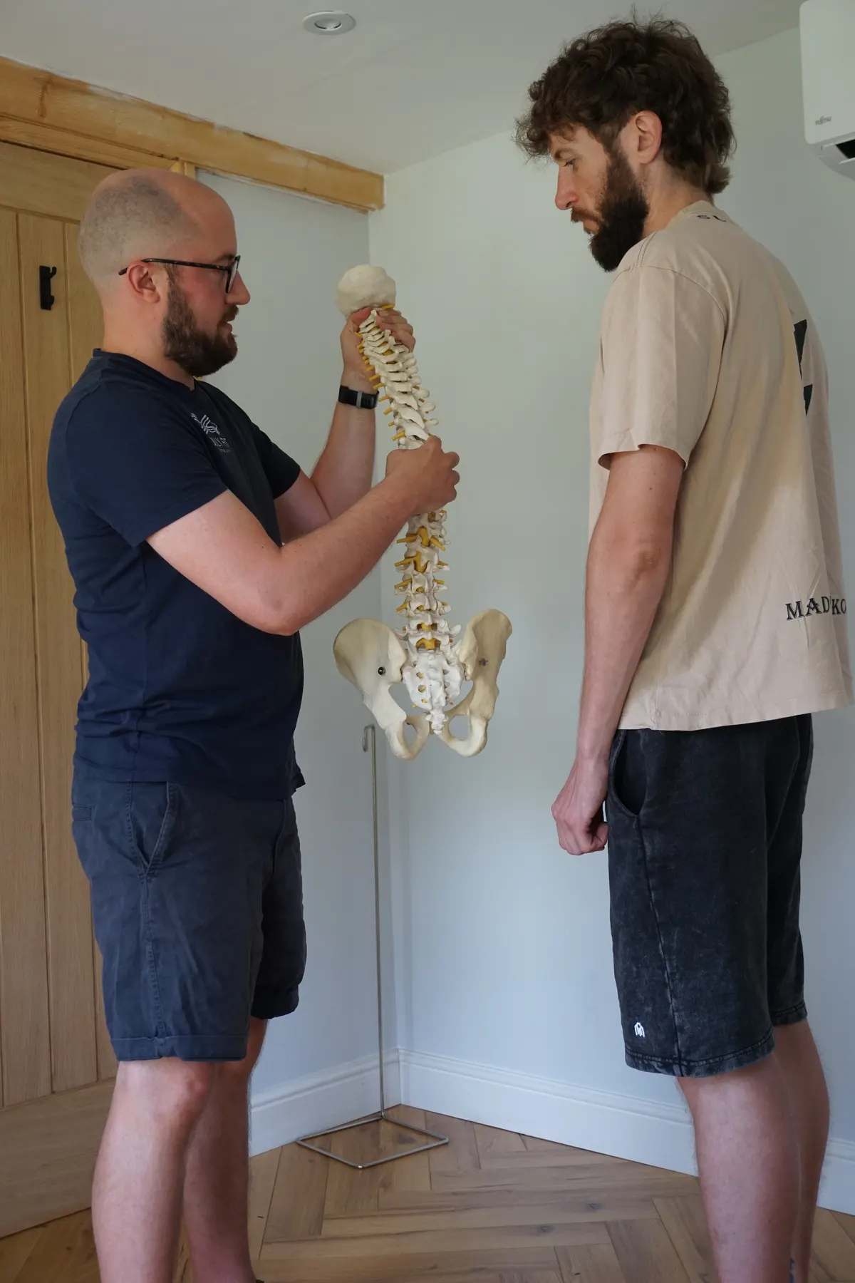 Rob explaining a spinal issue using an anatomy model